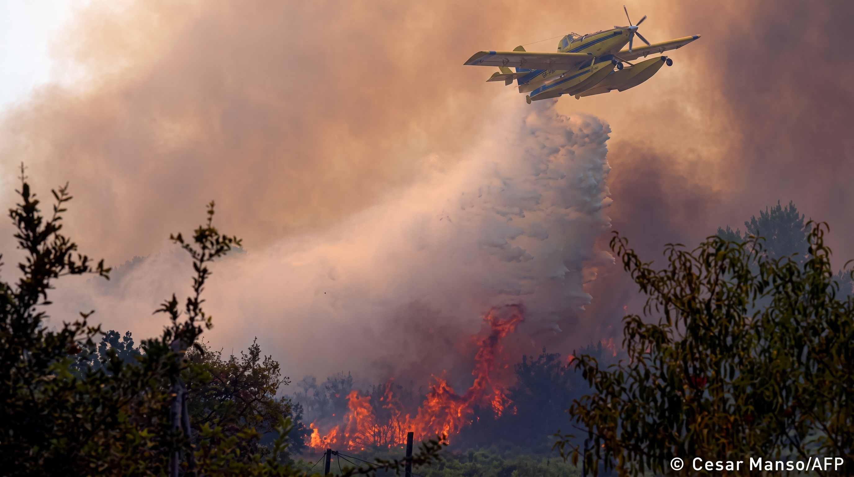 Aerial firefighting plane drops water on wildfire near Madrid Spain
