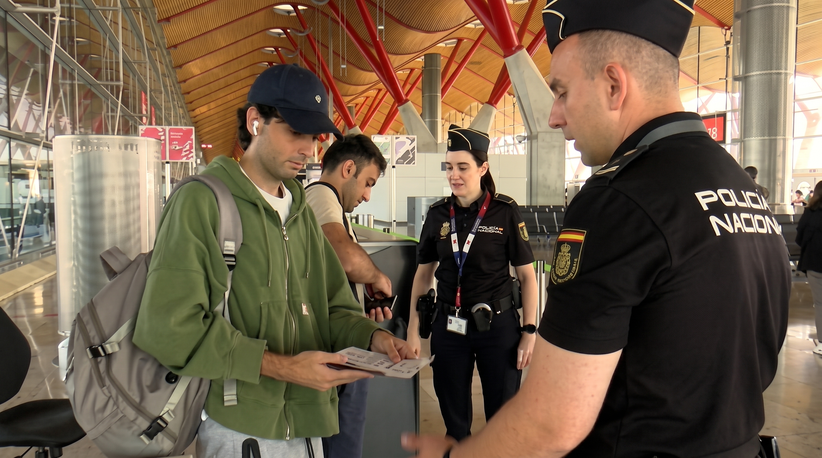 Spanish police checking documents at Madrid airport from Italian flight