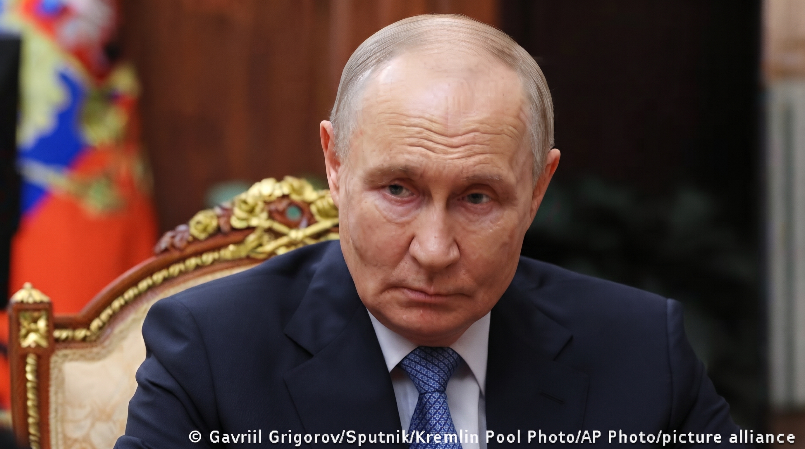 Vladimir Putin signing documents at Kremlin