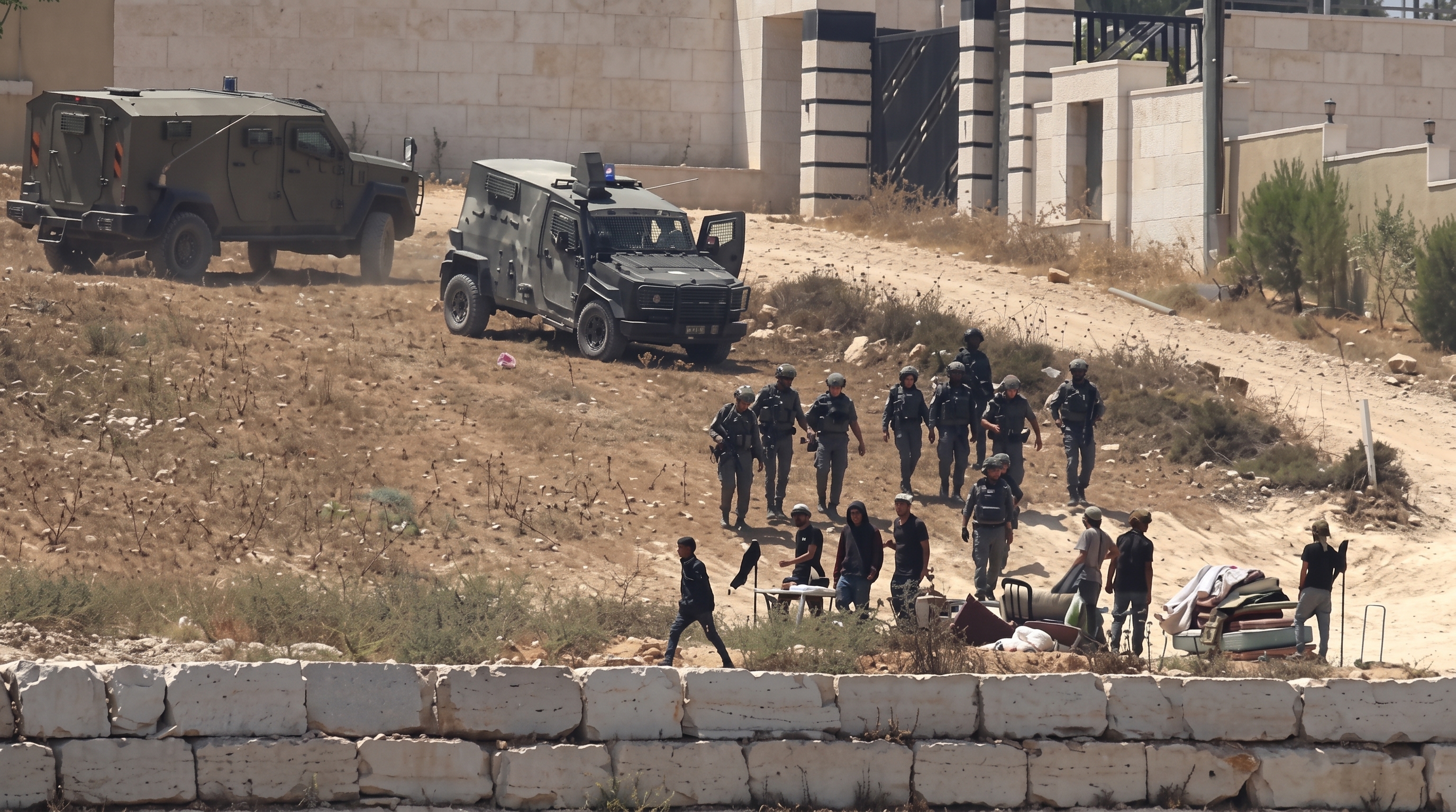 Israeli soldiers and settlers in Kusra, West Bank