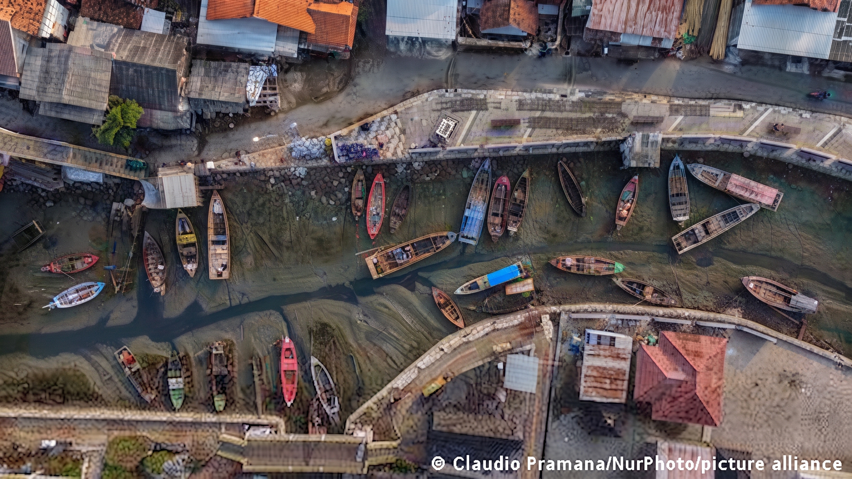 Fishing boats stranded in mud in Tangerang, Indonesia during El Niño drought