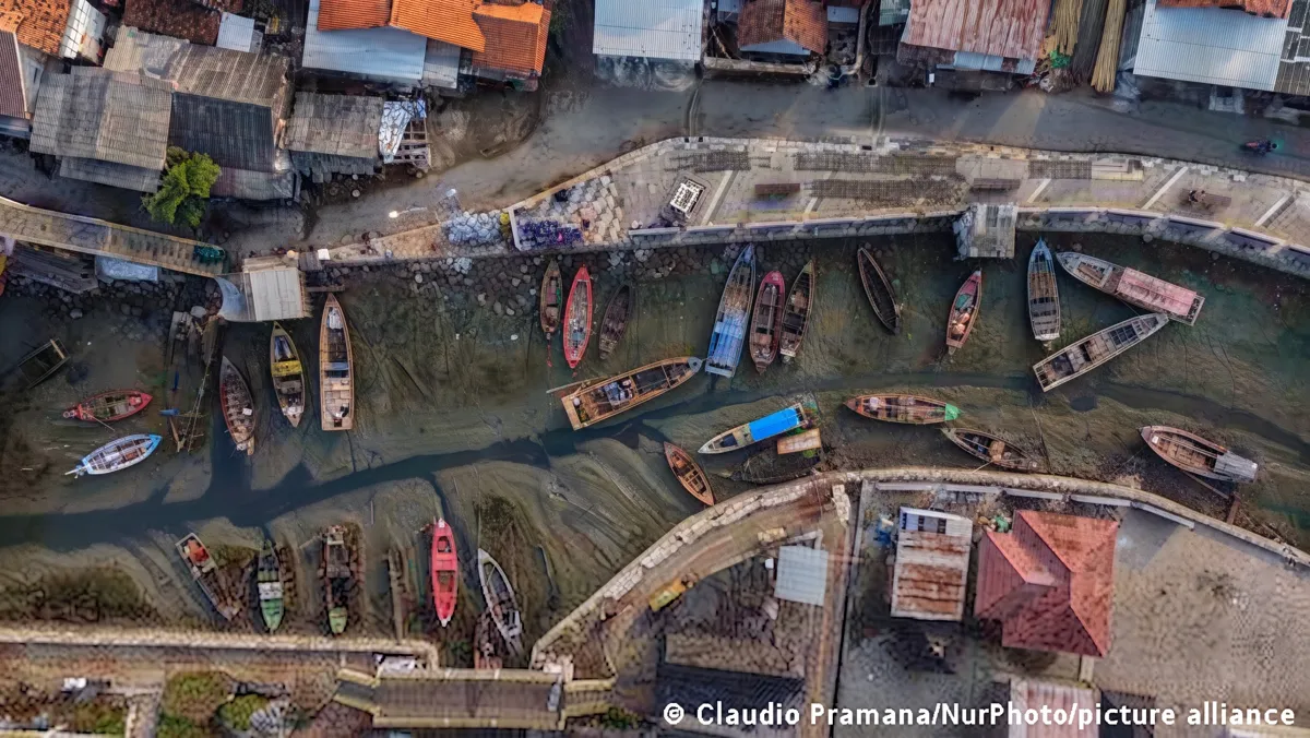 Fishing boats stranded in mud in Tangerang, Indonesia during El Niño drought