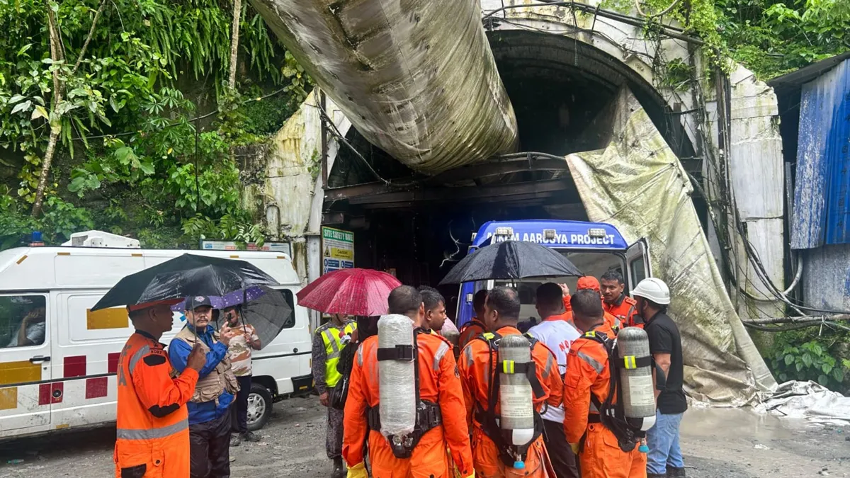 Rescue teams with oxygen cylinders at the Samardung tunnel collapse site in India