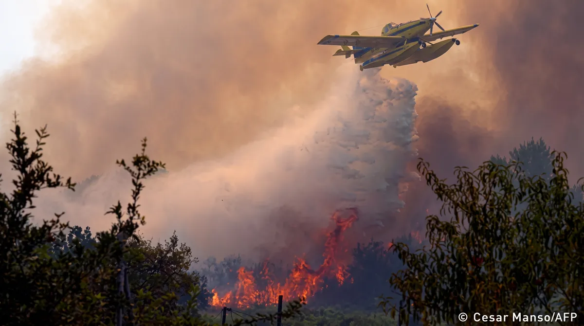 Aerial firefighting plane drops water on wildfire near Madrid Spain